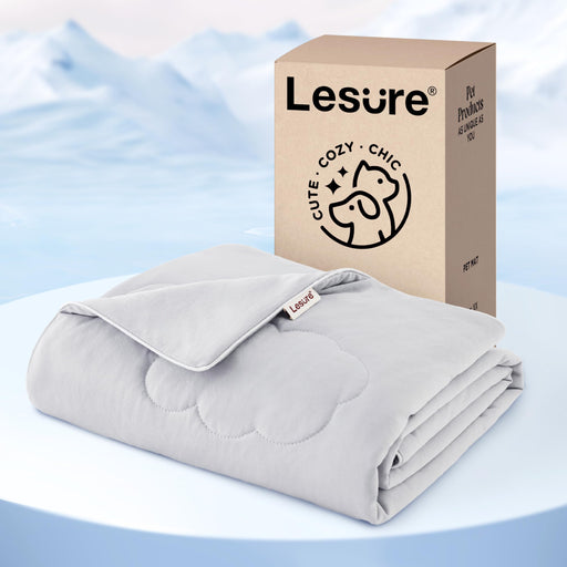 Gray cooling dog blanket folded next to tan Lesure packaging box with cute cozy chic logo