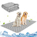 Gray cooling mat with white pattern shown flat and folded, two golden retrievers sitting on mat