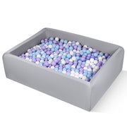 Gray rectangular foam ball pit filled with pastel purple blue and white balls
