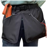 Gray dog training apron worn around waist showing side pockets and belt with orange item visible