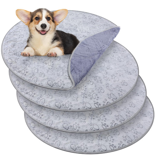 Corgi puppy sitting on gray waterproof training pads with paw print pattern stacked in layers