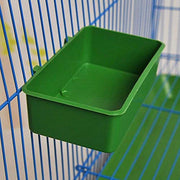 Green plastic bird food cup attached to blue wire cage bars with hooks