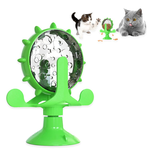 Green rotating cat treat dispenser with clear chamber containing kibble, suction cup base visible