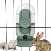Green automatic hanging water dispenser mounted on cage bars with ferret and rabbit nearby