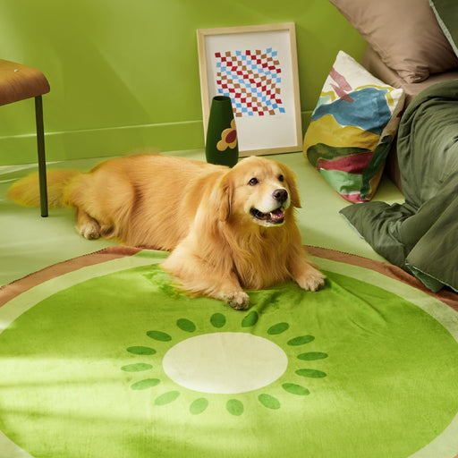 Golden retriever lying on green kiwi fruit pattern round rug in bright living room
