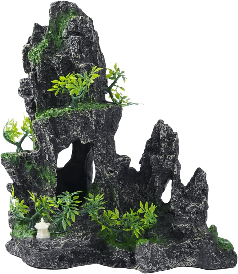 Dark grey rocky aquarium cave decoration with artificial green plants and small white pagoda