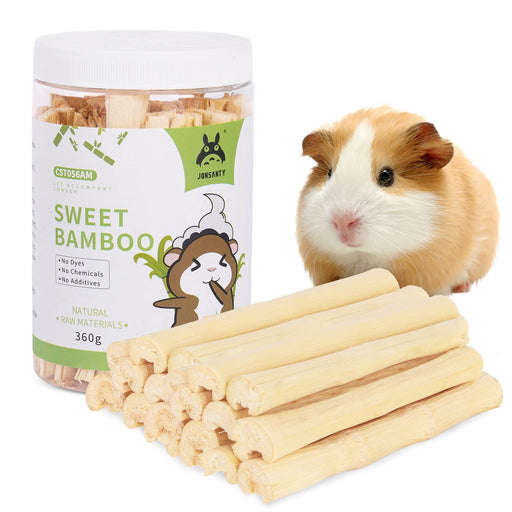 Guinea pig next to sweet bamboo chew sticks and product container on white background