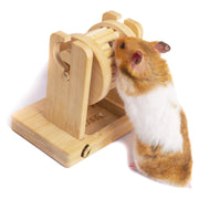 Orange and white hamster caught in wooden bamboo trap puzzle toy with mouth open