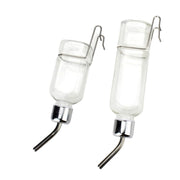Two clear glass water bottles with metal spouts and wire hangers on white background