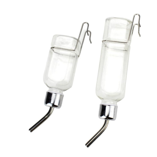 Two clear glass water bottles with metal spouts and wire hangers on white background