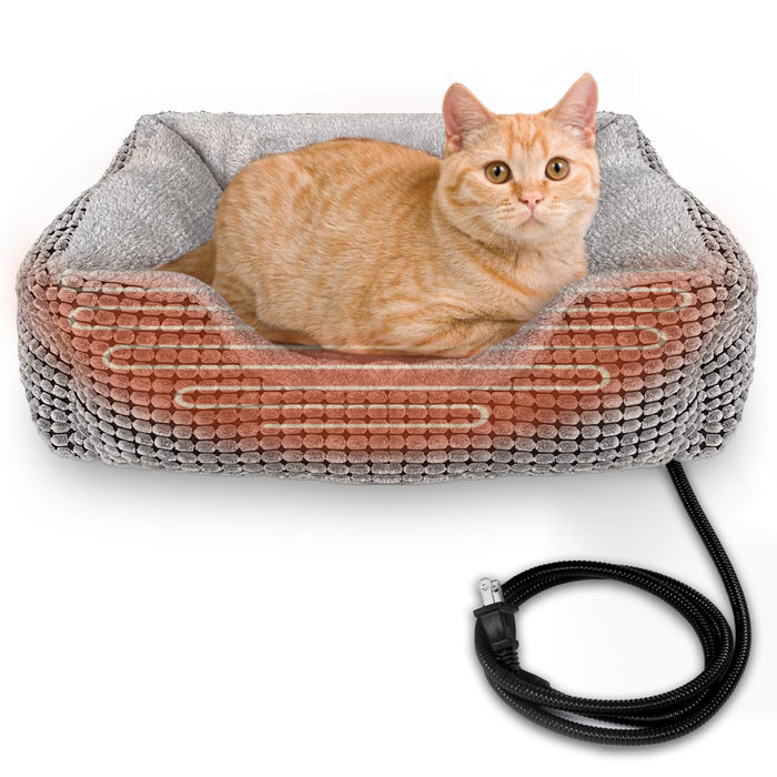 Orange tabby cat lying in gray and coral heated pet bed with USB power cord visible