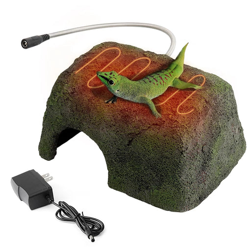 Green gecko on heated resin cave hide with glowing orange heating element and power adapter