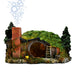 Hobbit house aquarium decoration with moss-covered roof, brick chimney, and round wooden door