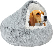 Beagle dog sitting inside gray faux fur donut cuddler bed with hood covering its head
