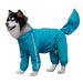 Husky dog wearing turquoise waterproof raincoat with hood and four legs covered