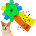 Colorful interactive dog snuffle ball with textured flaps dispensing kibble treats next to corgi