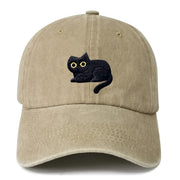 Khaki washed cotton dad hat with embroidered black cat with yellow eyes on front panel
