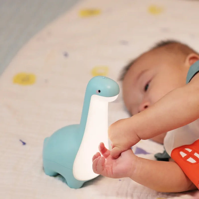 Dinosaur touch light on nightstand in kids bedroom setting
