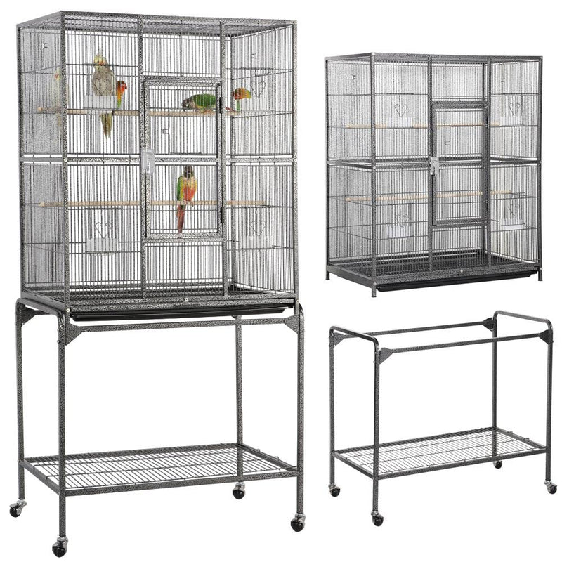 Two large wire bird cages on rolling stands with multiple compartments, some containing parrots