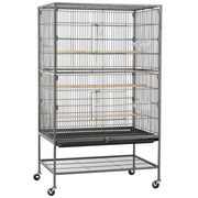 Large gray metal bird cage with wooden perches and food bowls on wheeled stand