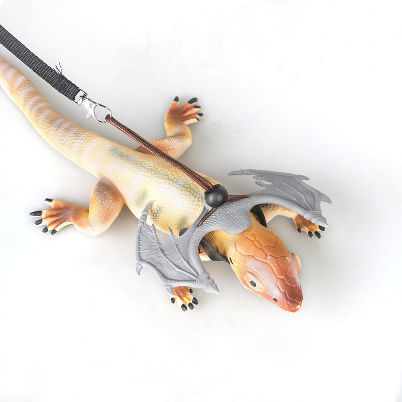 Orange silicone lizard toy with gray dragon wings and black nylon leash attached