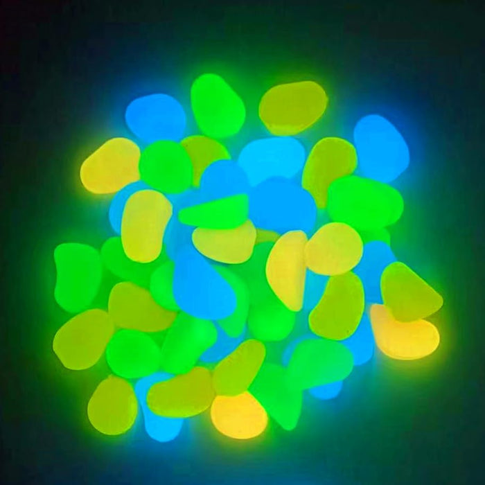 Glowing aquarium rocks in blue, green and yellow colors creating luminous bokeh effect