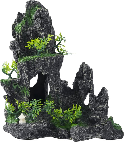 Dark gray rock aquarium decoration with green moss, artificial plants and cave openings