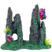 Gray rock aquarium ornament with cave opening, green moss details and colorful betta fish