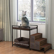 Gray cat sitting on elevated brown cushioned perch beside window with wooden steps attached