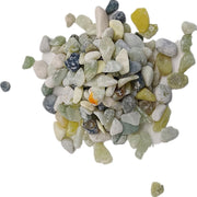 Collection of natural green aquarium gravel stones in various shades scattered on white background