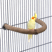 Yellow cockatiel perched on curved natural wood U-shaped perch inside wire bird cage
