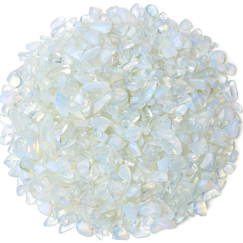 Pile of translucent opal crystal chips with blue and white iridescent shimmer on white background