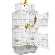 White wire bird cage with open doors showing colorful parrots perched on wooden dowels inside