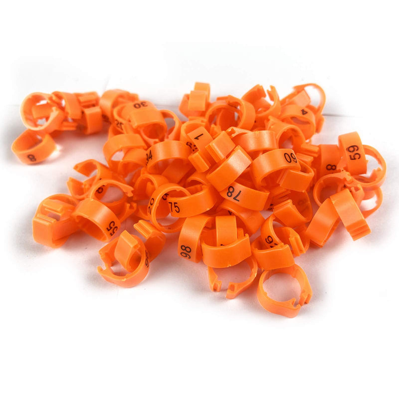 Close-up of orange plastic bird leg bands with black numbers scattered on white background