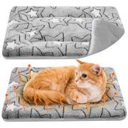 Orange tabby cat lying on gray star-patterned thermal mat with orange heat arrows showing warmth