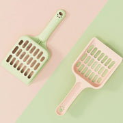 Two cat litter scoops in mint green and soft pink colors with paw print designs on handles