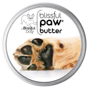 Round silver tin of Blissful Dog paw butter with close-up image of dog paw pads on white label