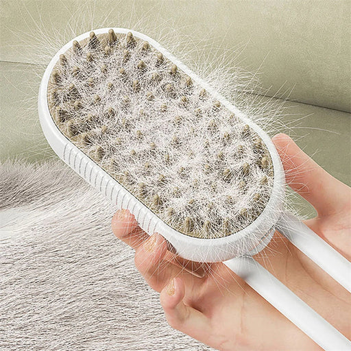 Hand holding white pet grooming brush with fur collected on bristled surface