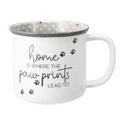 White ceramic mug with paw print design and home quote shown at slight angle
