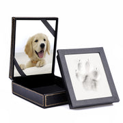 Black leatherette keepsake box open showing golden retriever photo and clay paw print tile
