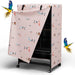 Pink bird cage cover with colorful bird pattern and two flying parrots on white background