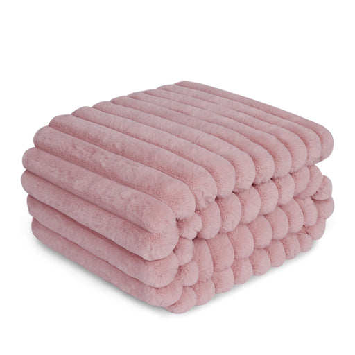 Pink ribbed double-layer dog blanket folded and stacked showing soft textured surface