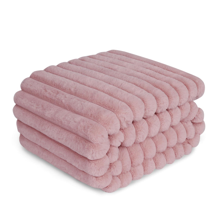 Pink ribbed double-layer dog blanket folded and stacked showing soft textured surface