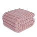 Pink ribbed waterproof dog blanket stacked in multiple layers showing plush textured surface