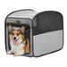 Gray and black portable dog crate with mesh panels and corgi sitting inside front opening