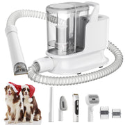 White pet grooming vacuum with clear canister, flexible hose, and brush attachments next to two dogs