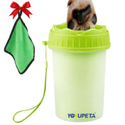 Green dog paw cleaner cup with puppy paws inside, microfiber towel with red bow hanging nearby
