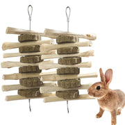 Natural wood and hay chew toy with hanging chains next to brown rabbit on white background