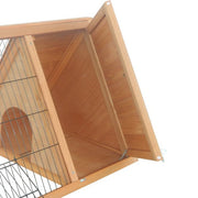 Interior view of wooden rabbit hutch showing triangular compartment and wire mesh door