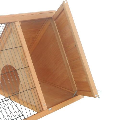 Interior view of wooden rabbit hutch showing triangular compartment and wire mesh door